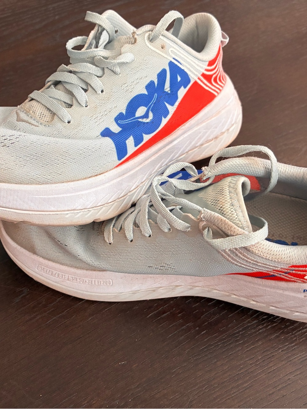 Hoka Carbon X Gray Running Shoes with Blue Logo and Orange Accents